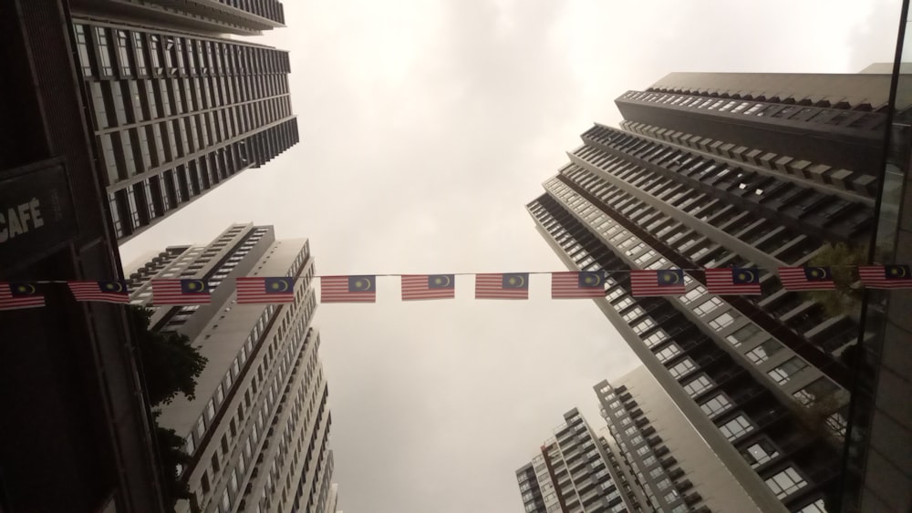 looking up at tall buildings in a city