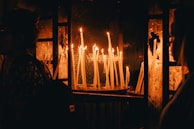 A moment of gratitude captured as guests reflect quietly, candles softly glowing nearby.