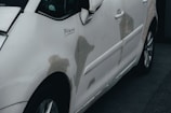 a white car parked in front of a building