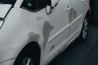 a white car parked in front of a building