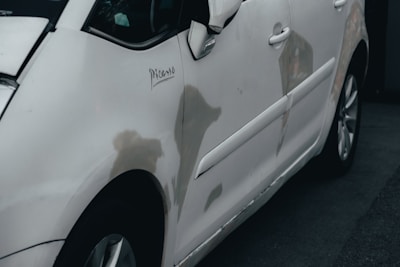 a white car parked in front of a building