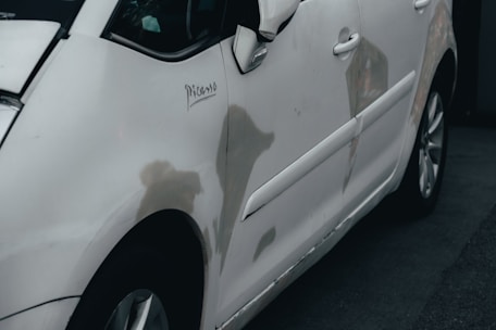 a white car parked in front of a building