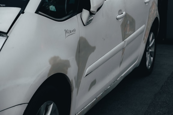 a white car parked in front of a building