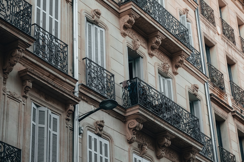 a tall building with lots of windows and balconies