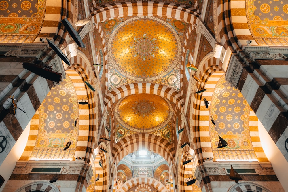 the ceiling of a building with a lot of gold and white designs