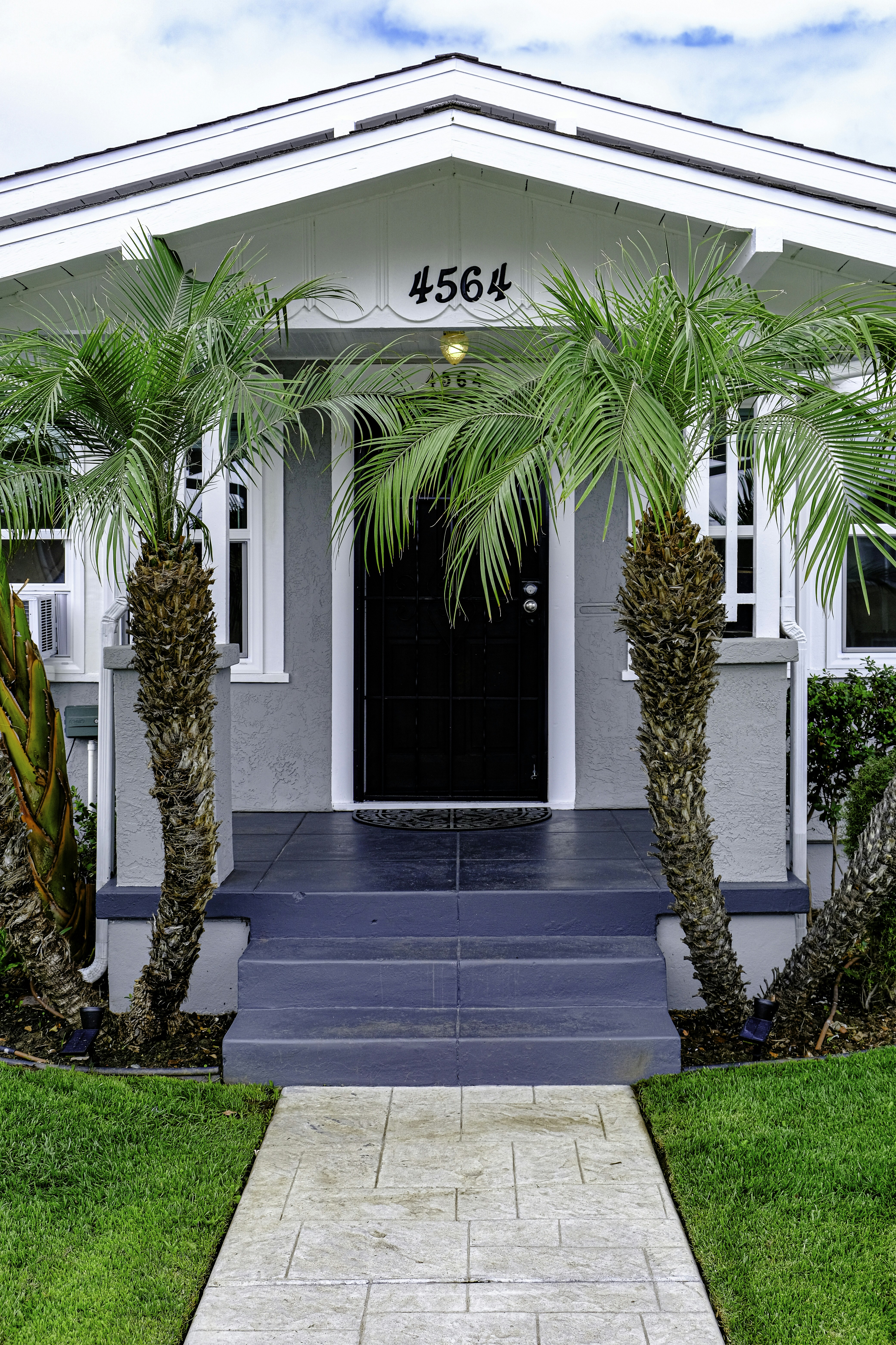 Spacious single-family house with a front garden and a welcoming porch, showcasing new construction.