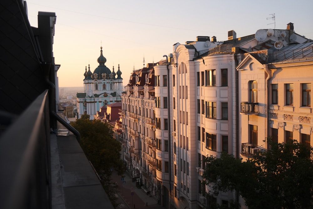 a row of buildings with a clock tower in the background