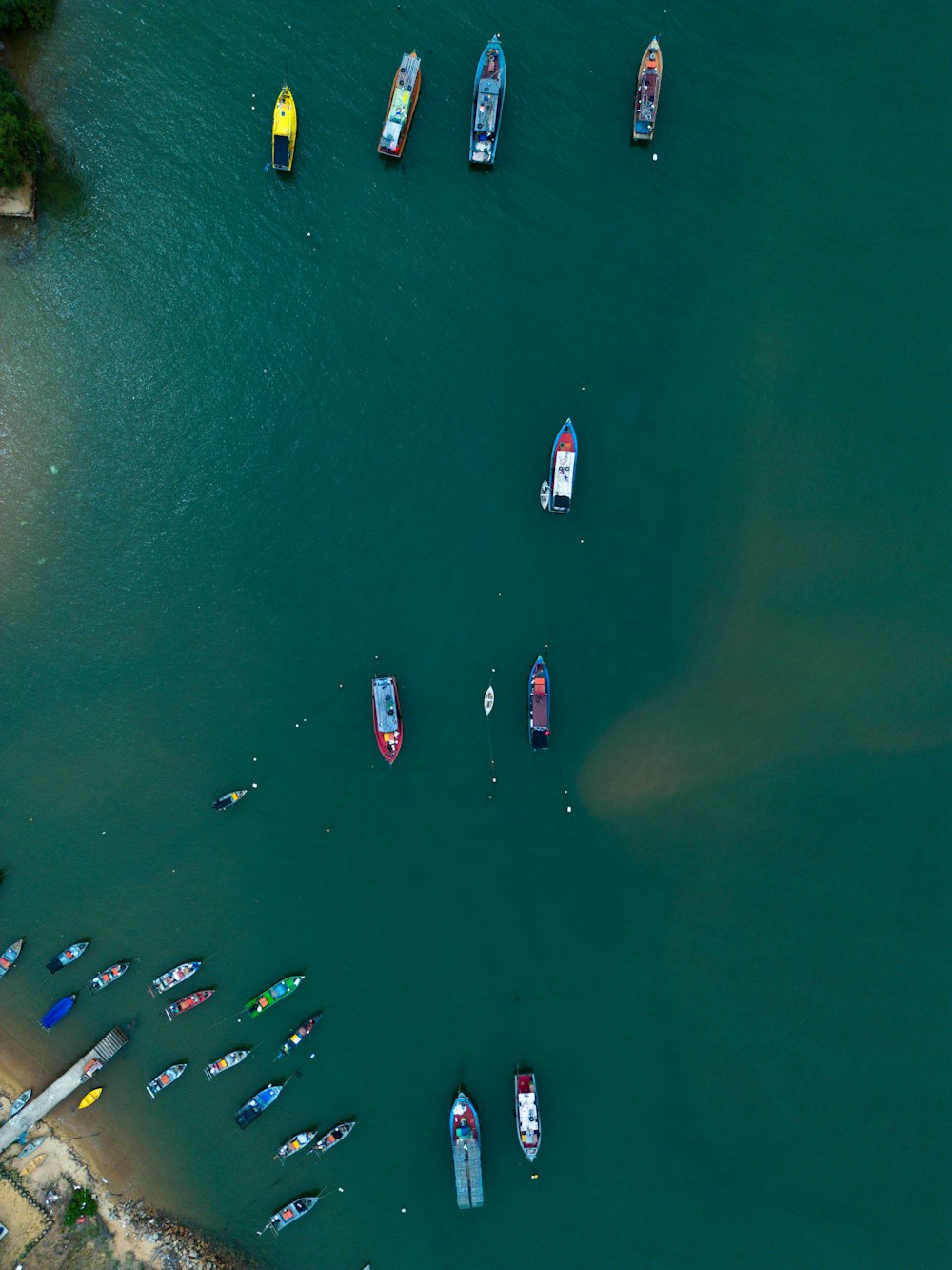 a group of boats floating on top of a body of water