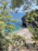 A serene hidden beach in Lombok with crystal-clear turquoise water and lush greenery.