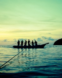 a group of people riding on top of a boat in the ocean