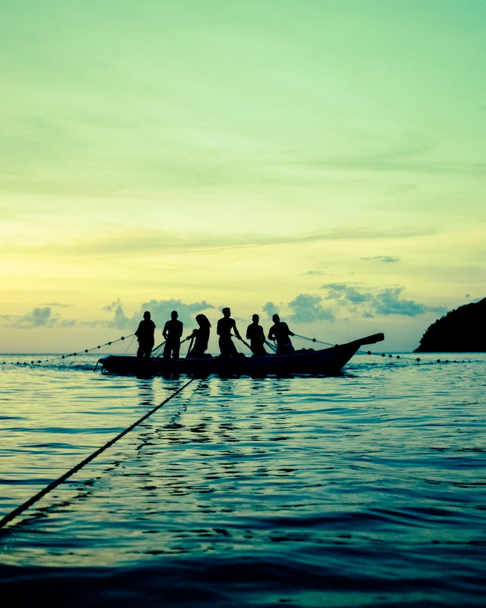 a group of people riding on top of a boat in the ocean