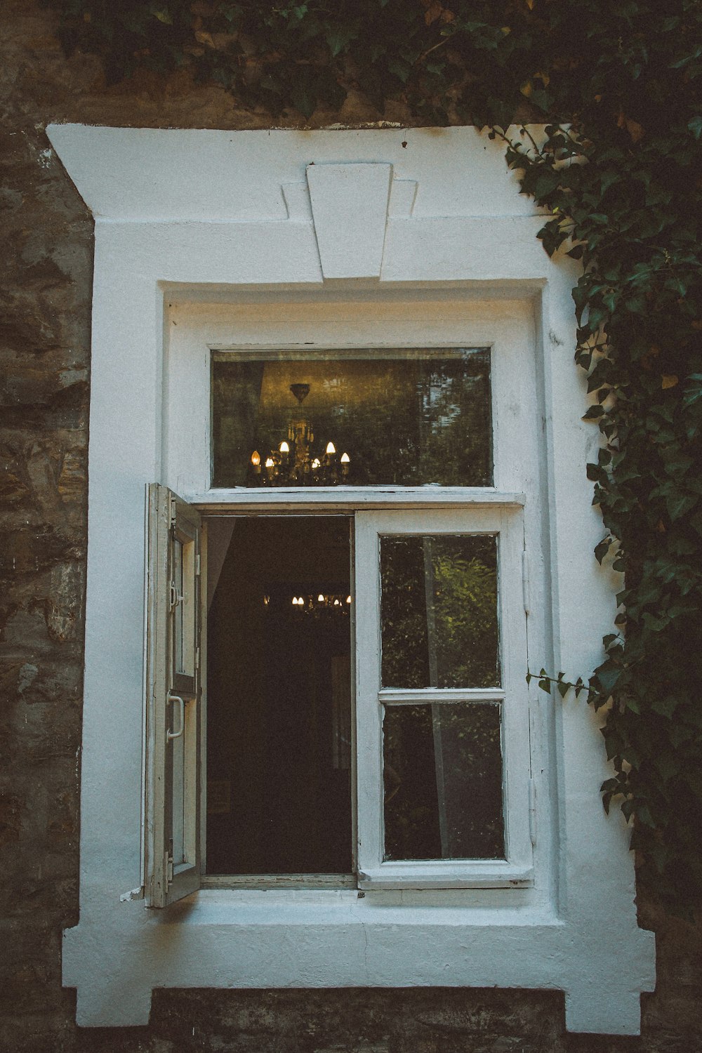 a white window sitting next to a brick wall