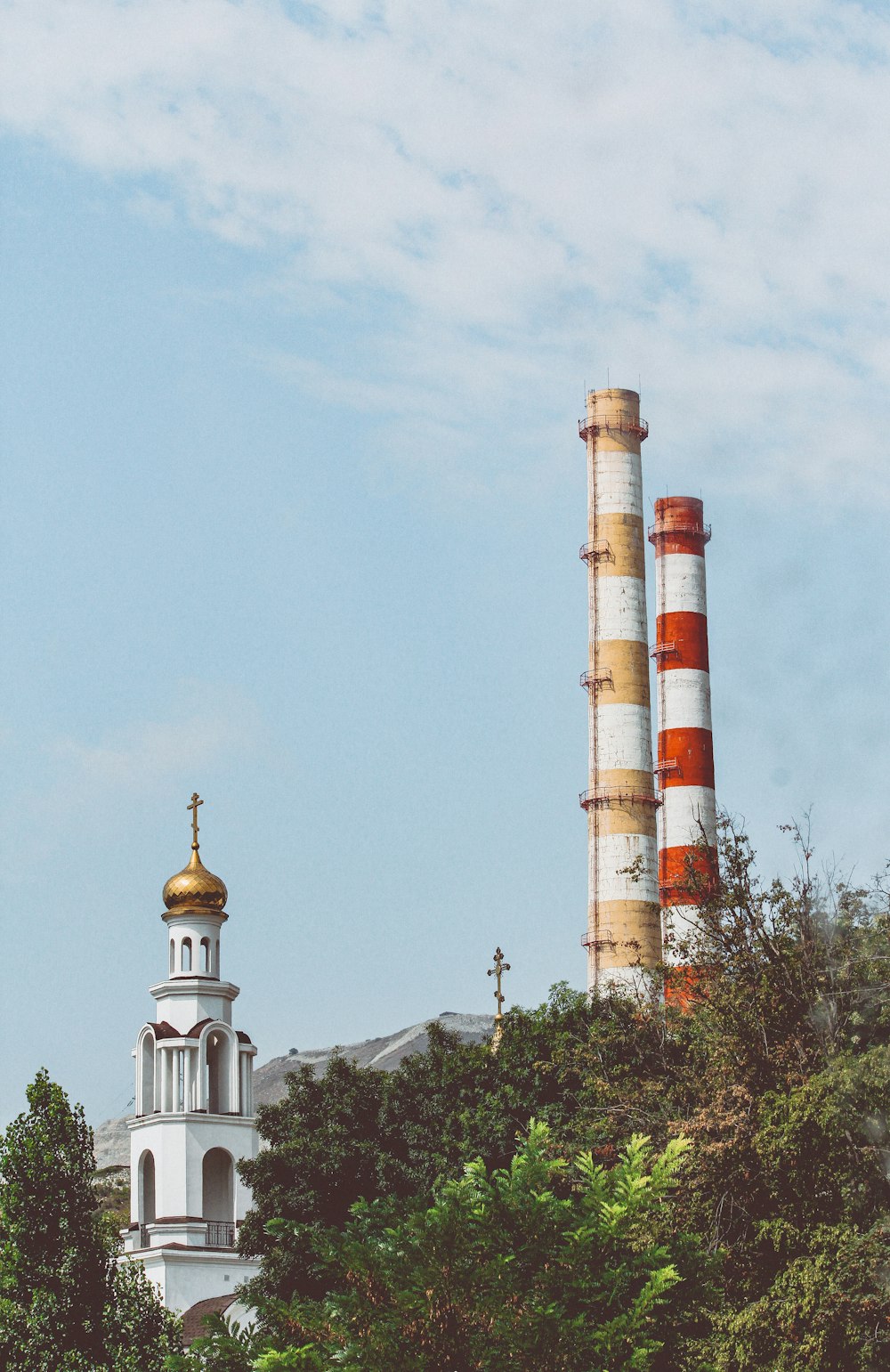 a tall tower with a cross on top of it