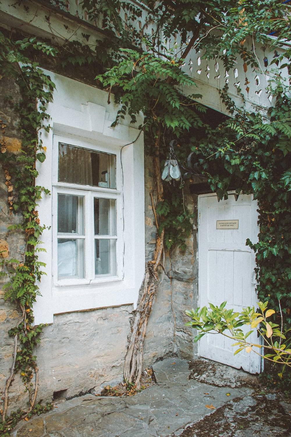 a white door and window on a stone building