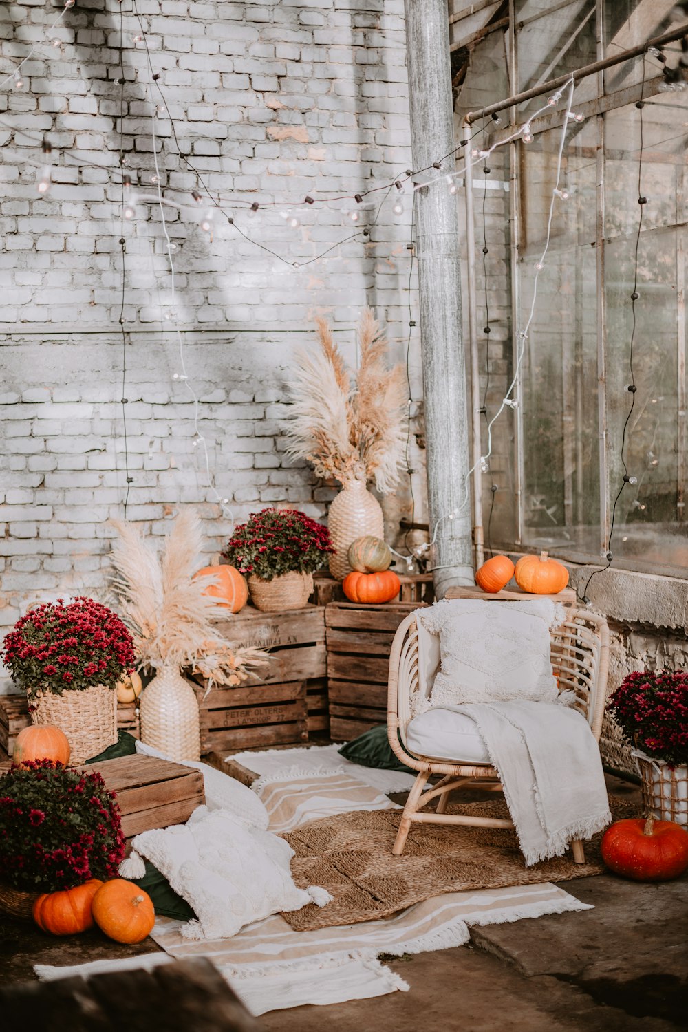a white chair sitting on top of a wooden crate filled with pumpkins