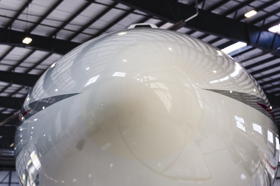 a large white object hanging from the ceiling, A White Private Jet