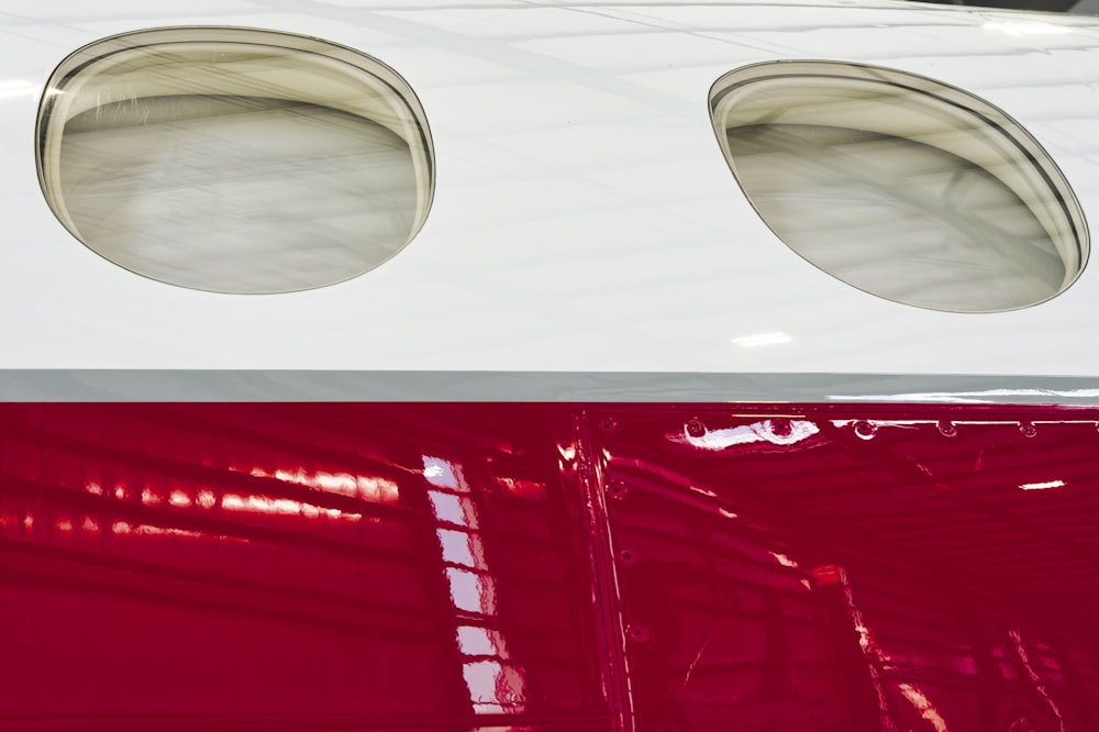 a close up of a red and white airplane