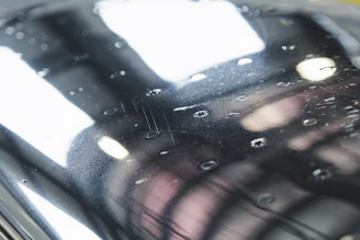Close-up of a glossy black epoxy floor reflecting soft lighting.