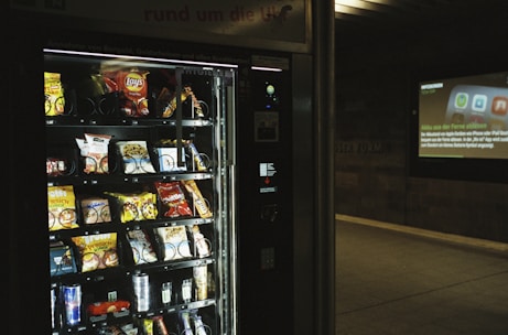 A modern vending machine stocked with various snacks and drinks.
