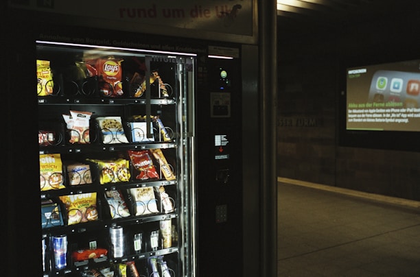 A modern vending machine stocked with various snacks and drinks.