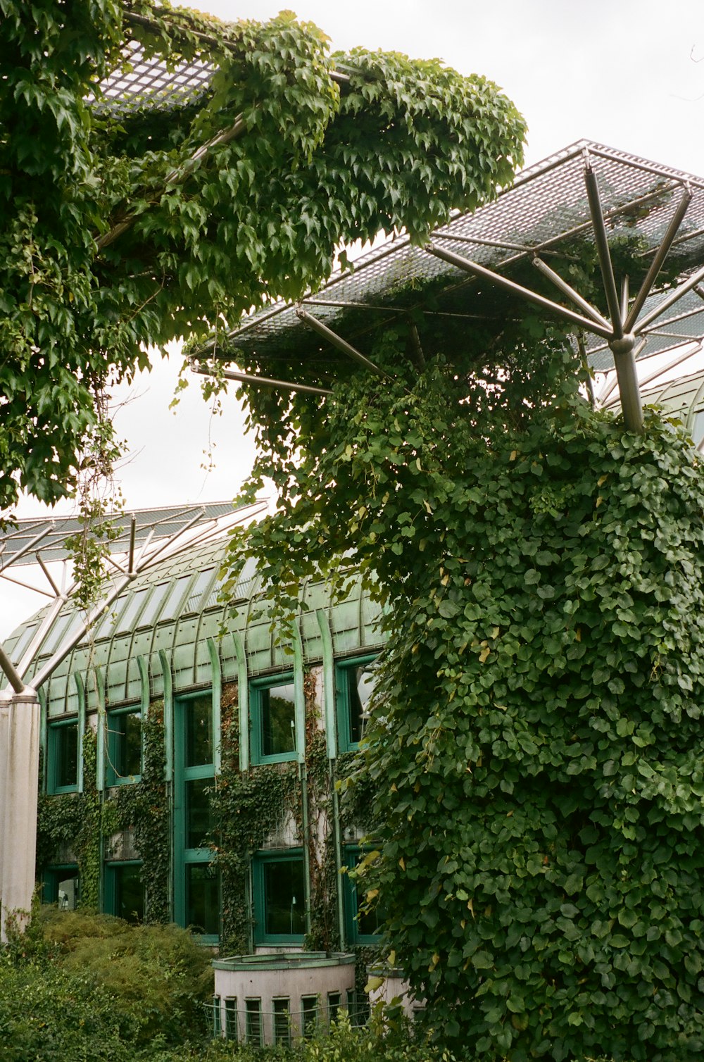 a building with a green roof and a white bench