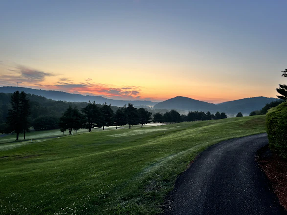 A serene sunrise over a winding path symbolizing the journey to wellbeing.
