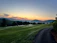A serene sunrise over the lush hills of Lomas del Expreso.