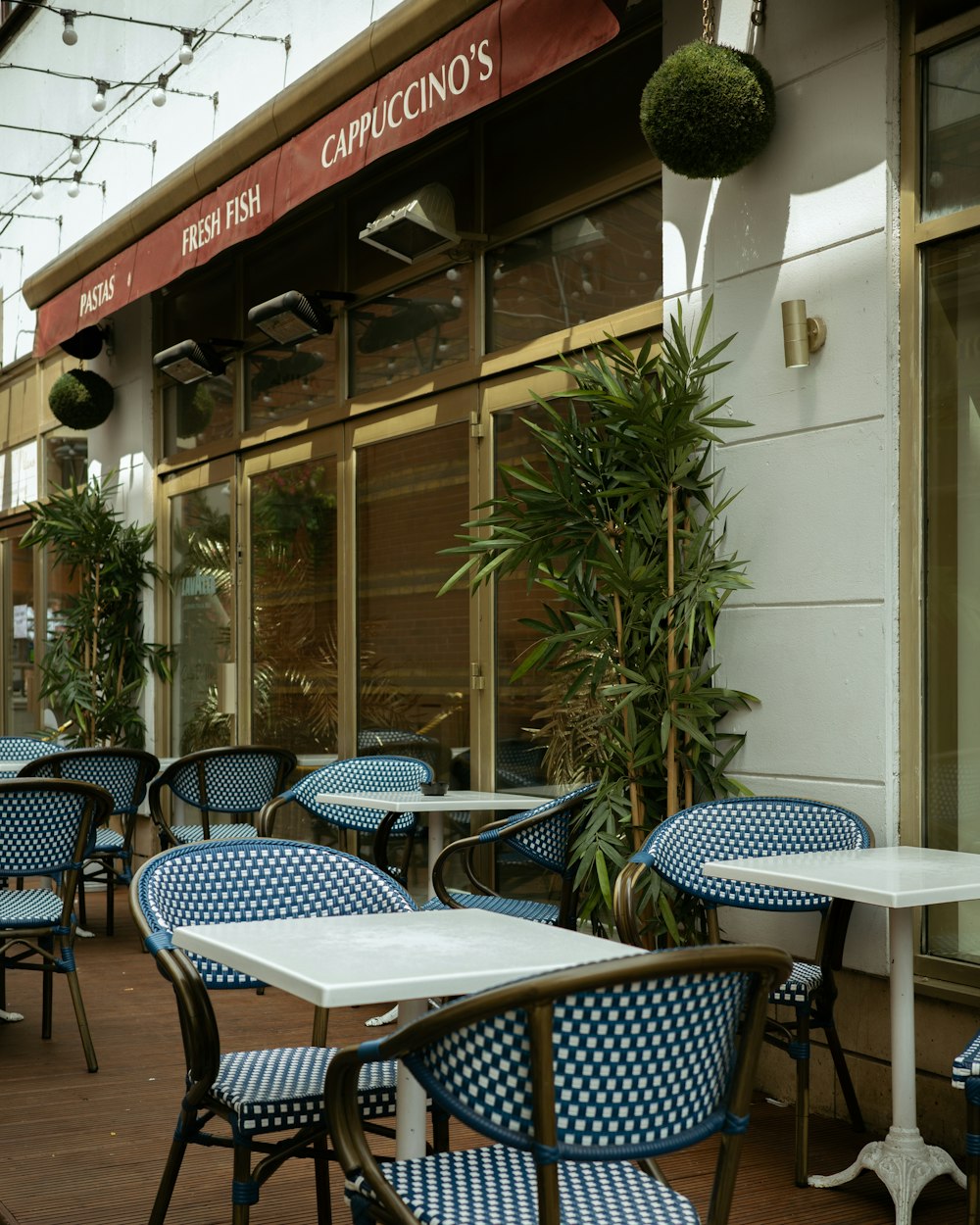 a restaurant with blue and white chairs and tables