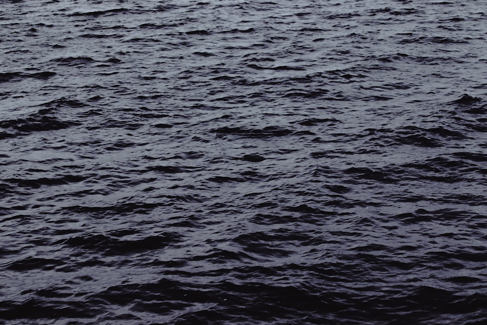 a boat floating on top of a large body of water