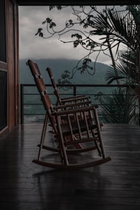 a rocking chair sitting on a wooden porch