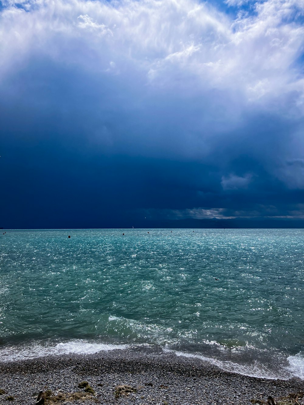 a large body of water under a cloudy sky