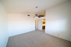 Open living space with colorful decor and a ceiling fan in the bungalow.