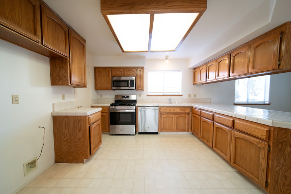 a kitchen with a stove, dishwasher, microwave and cabinets