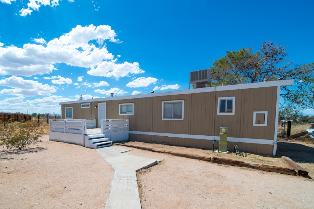 a couple of small houses sitting on top of a dirt field