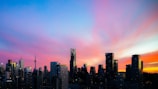 An iconic city skyline at sunset with vibrant colors.