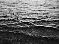 Minimalist encaustic painting capturing the gentle ripple of water with smooth wax layers.