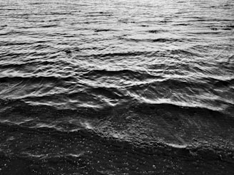 Minimalist encaustic painting capturing the gentle ripple of water with smooth wax layers.