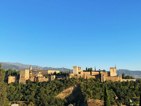 A majestic colonial fortress in Maluku surrounded by lush greenery and historical markers.