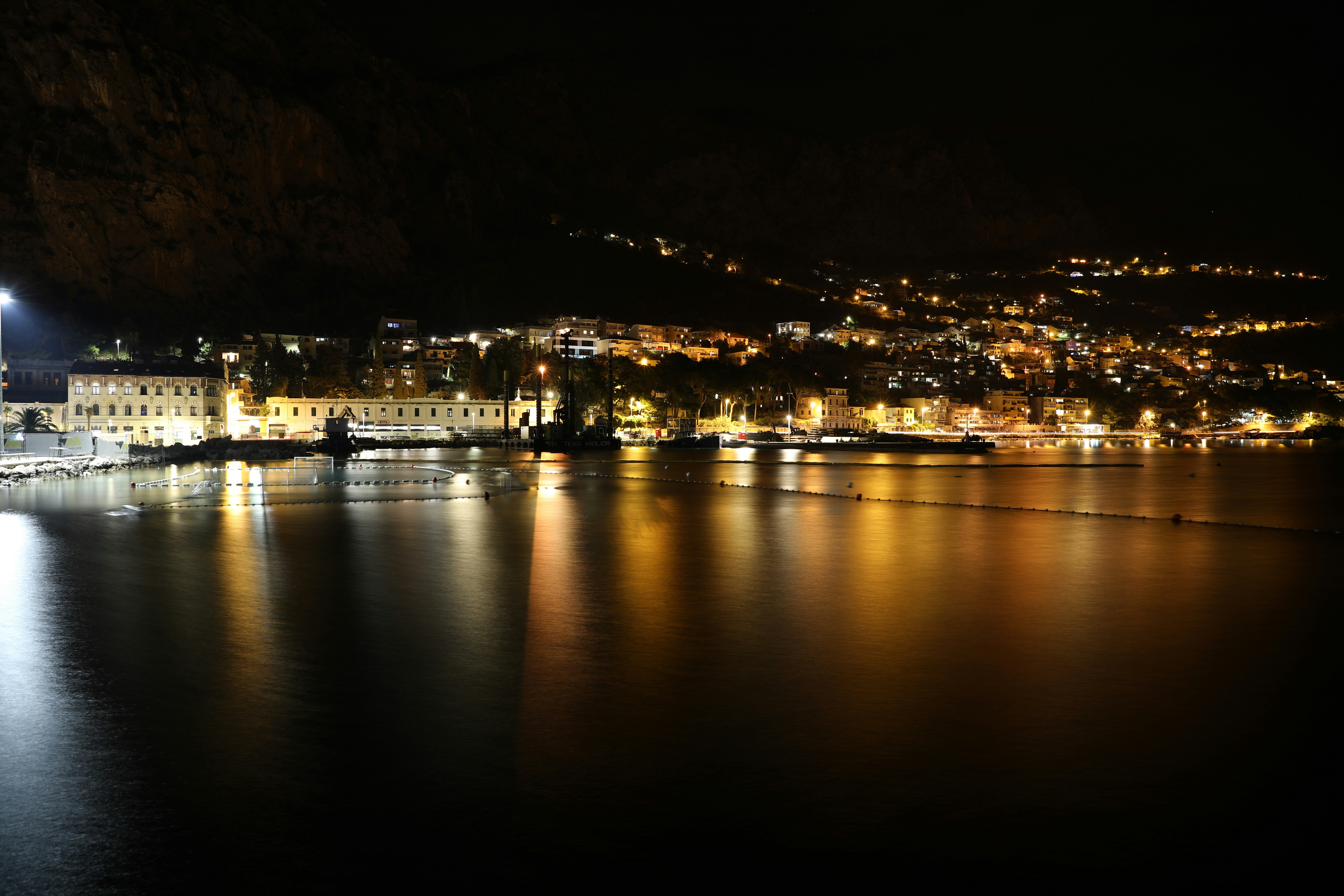 a large body of water with a city in the background