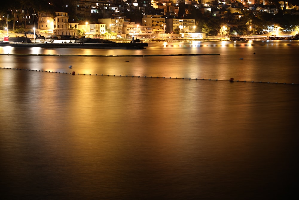 a body of water with a city in the background