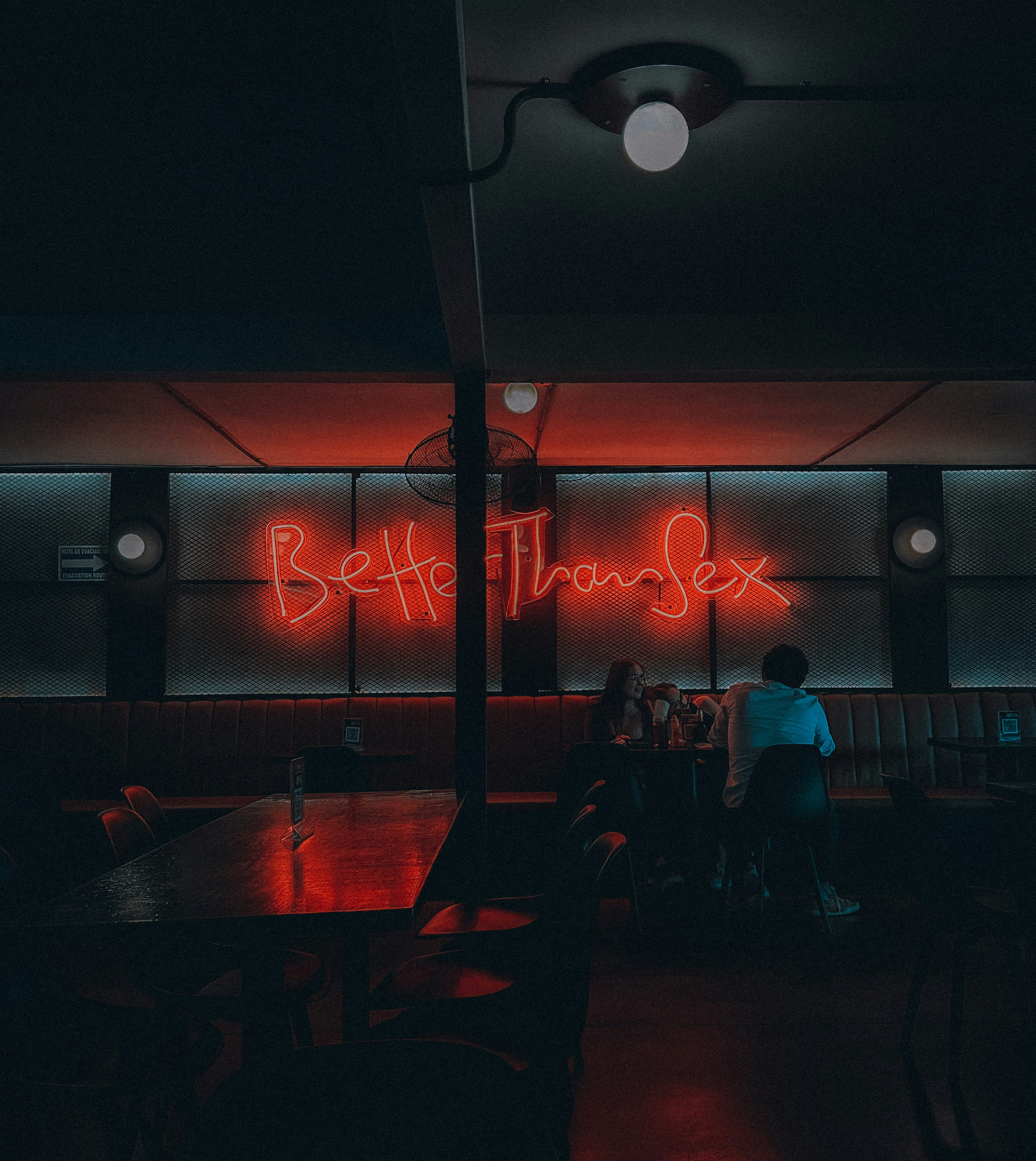 A person sitting at a table in a dark room