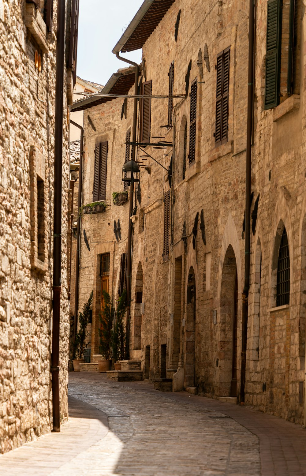 a cobblestone street lined with stone buildings