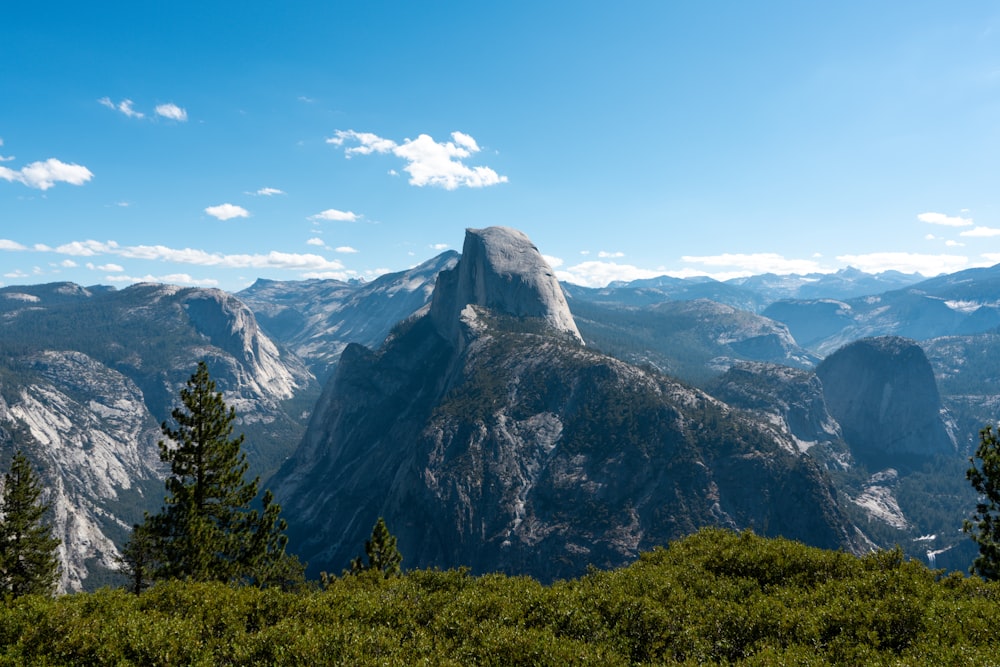 a view of a mountain range with trees in the foreground