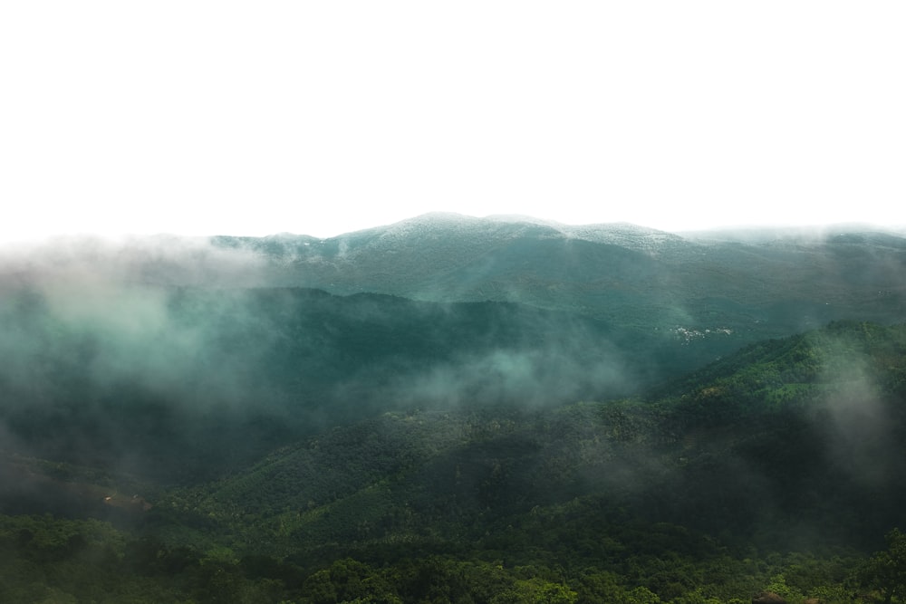 a view of a mountain range covered in clouds