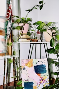 a table with plants and a painting on it