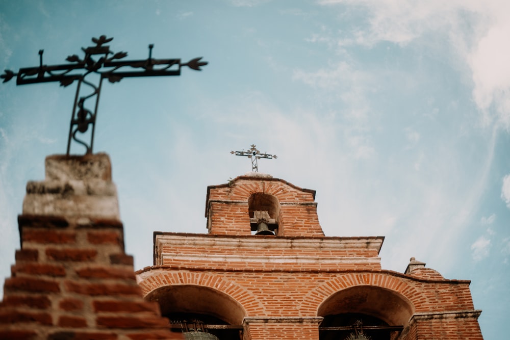 a brick building with a cross on top of it