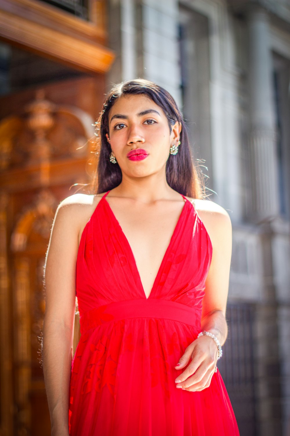 a woman in a red dress posing for a picture