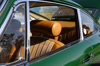 the interior of a green car with a sunroof