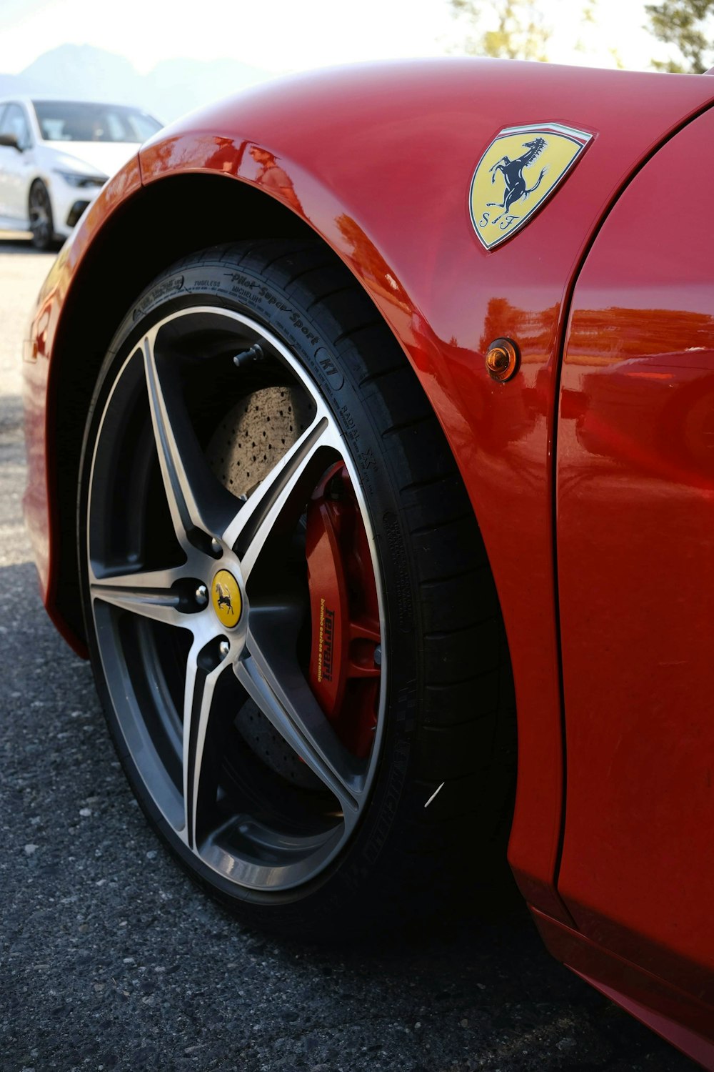 a close up of a red sports car tire