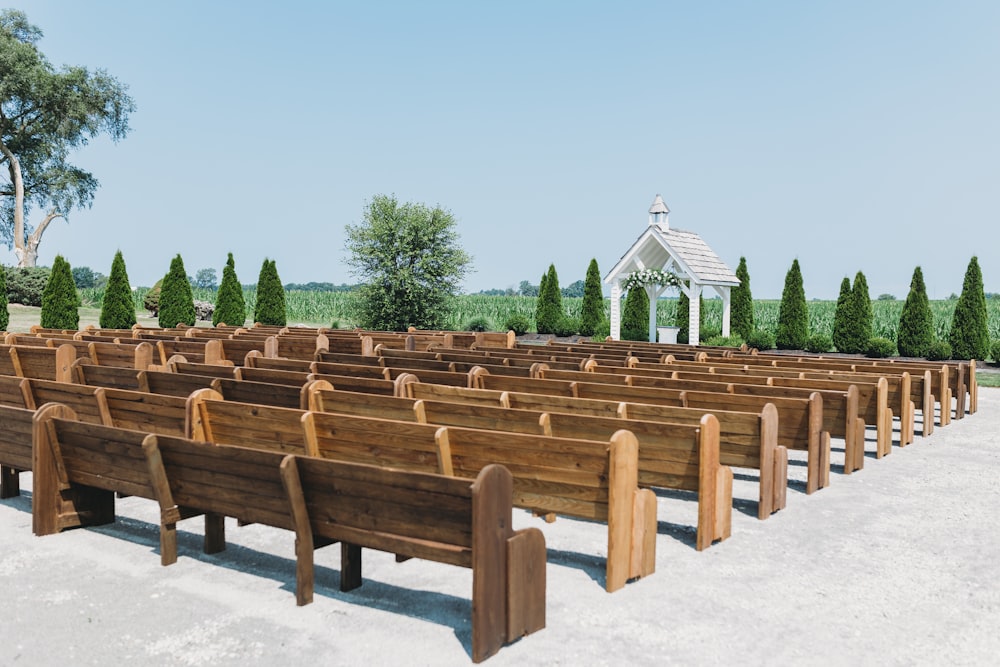 a row of wooden benches sitting next to each other